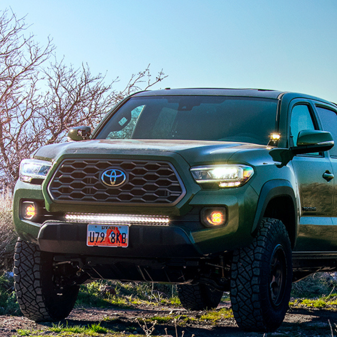 heretic's ba-2 pod light mounted as ditch lights on a toyota tacoma